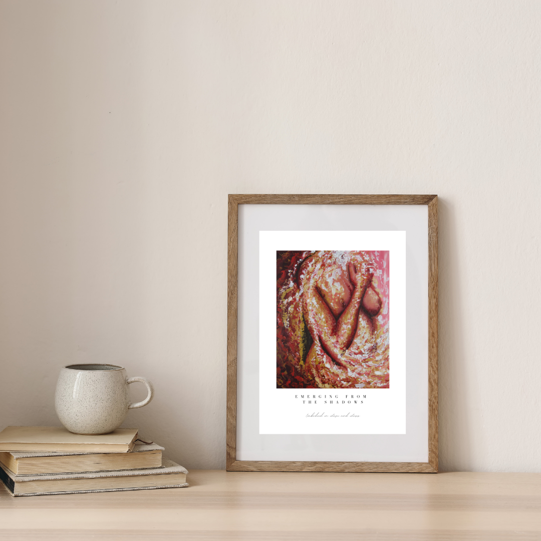 Framed artwork on a wall with a mug and books below