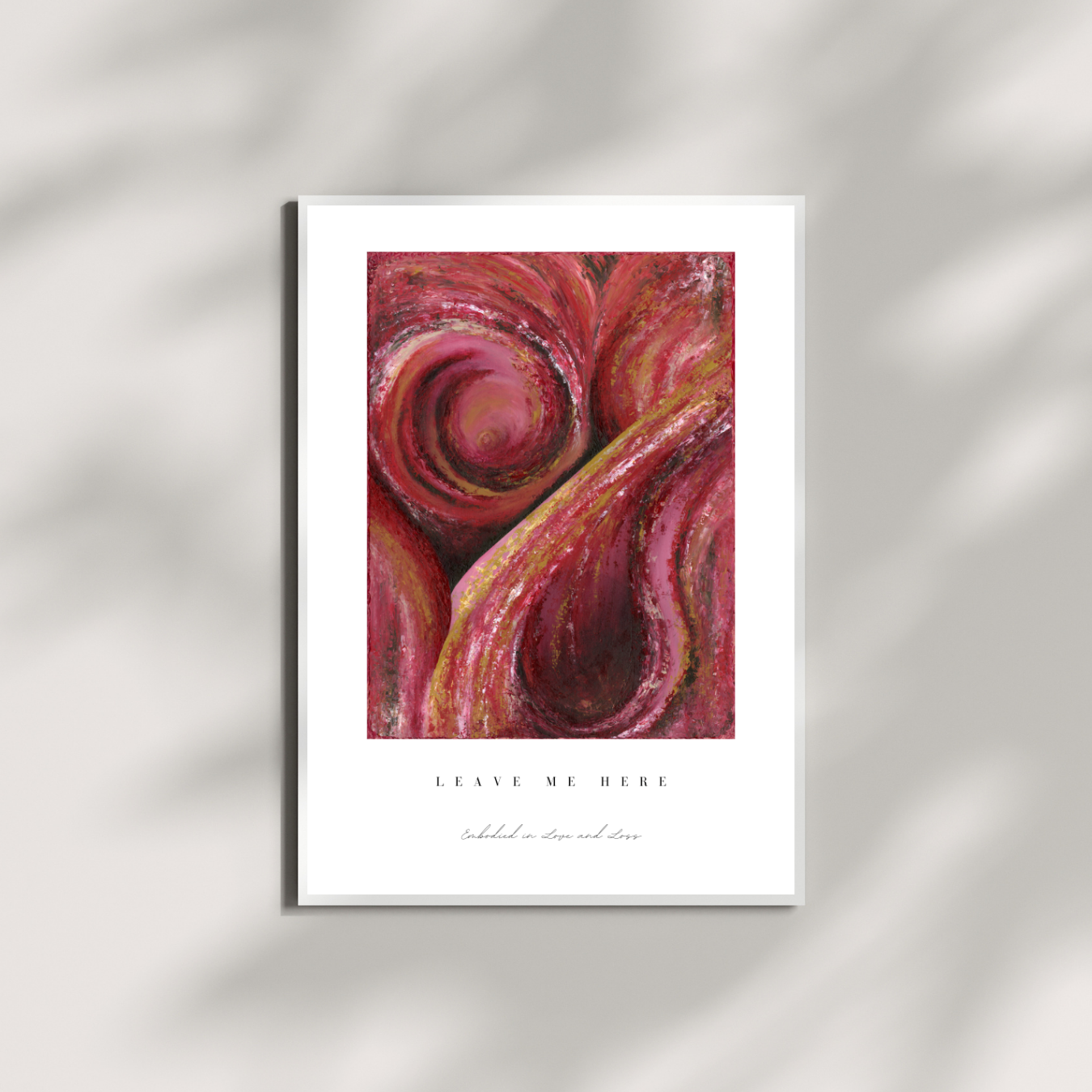 Framed abstract art print with swirling red and pink colors on a white background.