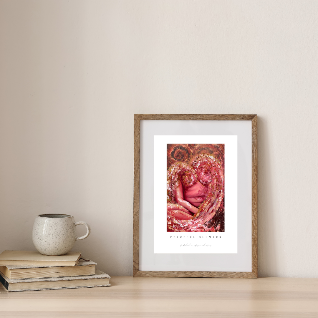 Framed artwork on a wall with books and a mug below