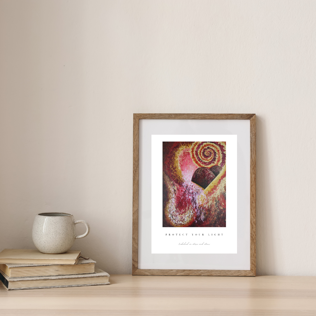 Framed abstract art print on a wall with books and a mug below