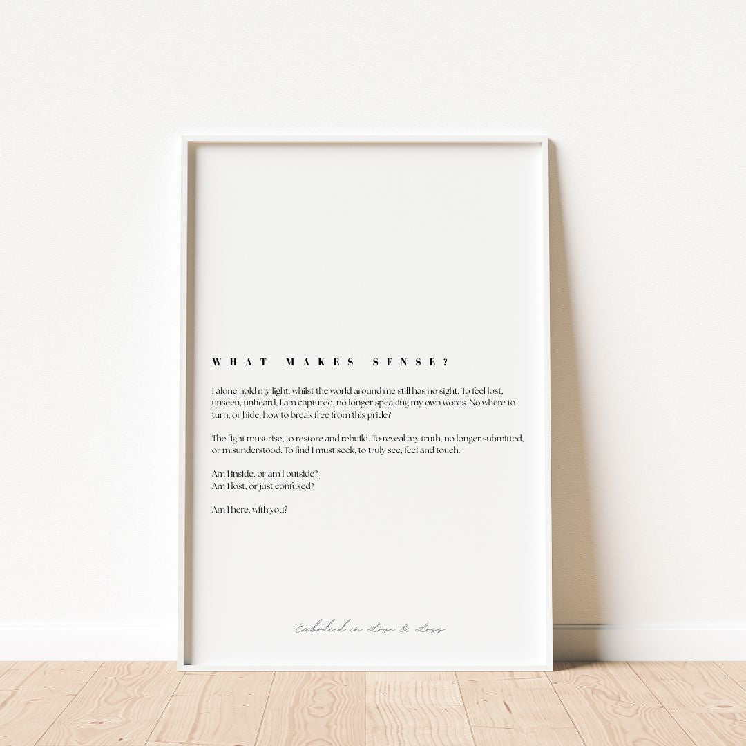 Framed text art print on a white wall with wooden floor.
