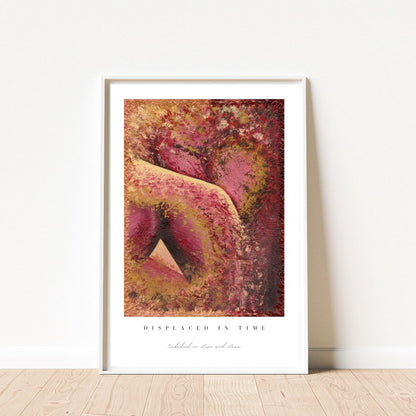 Framed abstract art print with warm colors on a white wall.