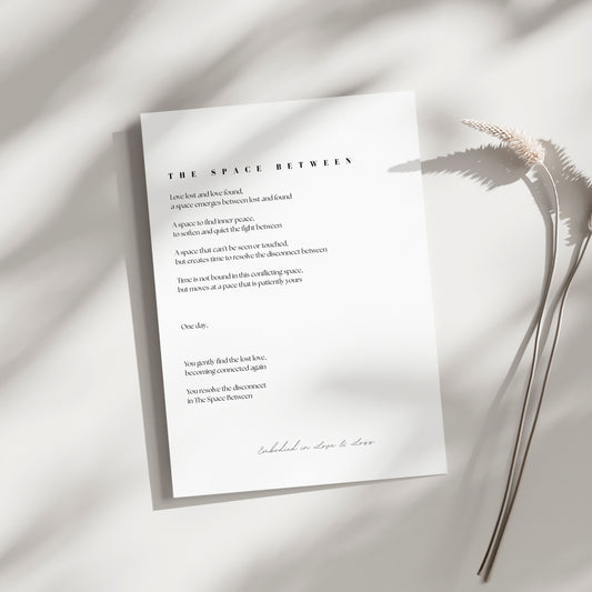 Sheet of paper with text on a light background with a plant leaf