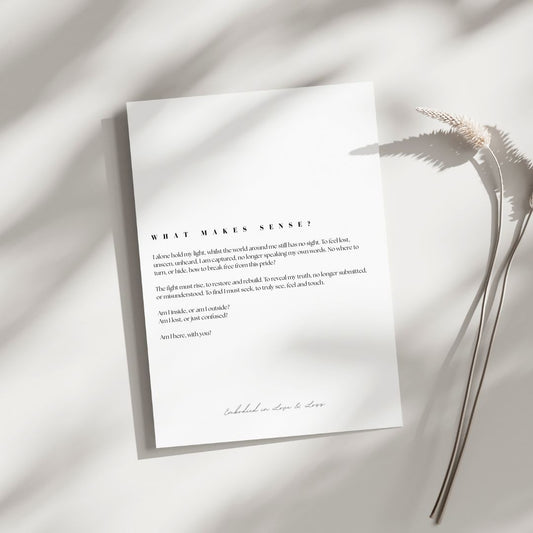 White paper with text on a light background with a plant leaf